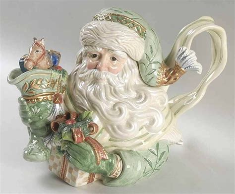 Box with colorful graphics. . Fitz and floyd santa teapot